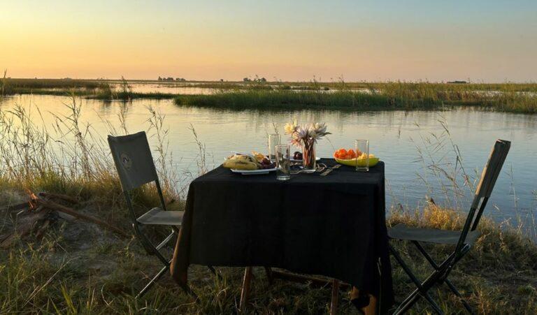 Table laid for breakfast for two, next to the Zambezi River