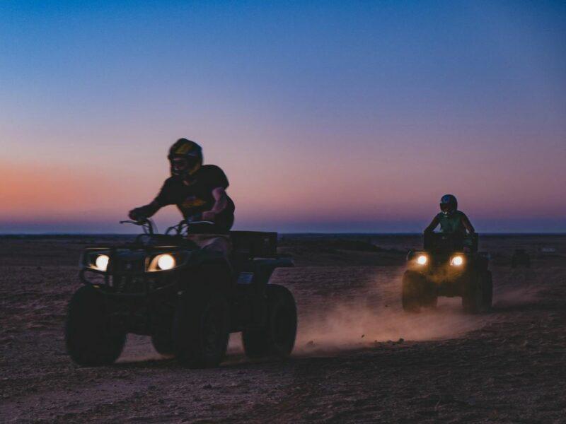 people driving on quad bikes