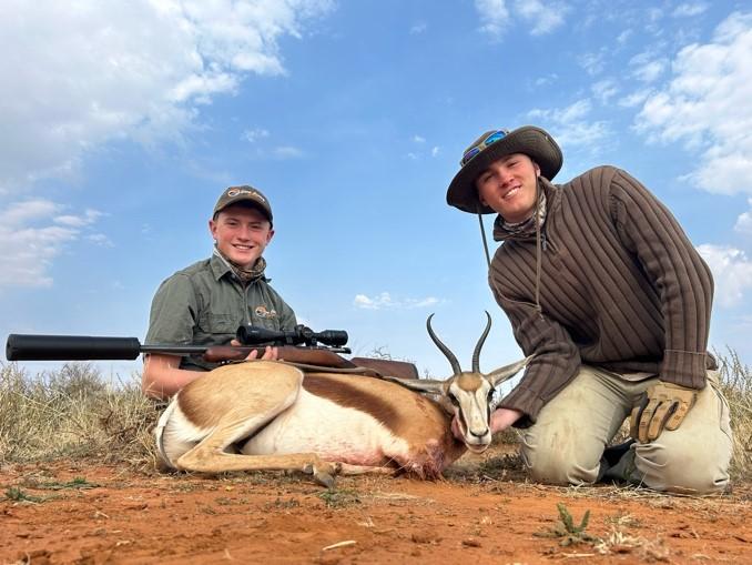 Slade and Logan with the Springbok Logan shot on the African plains game safari.
