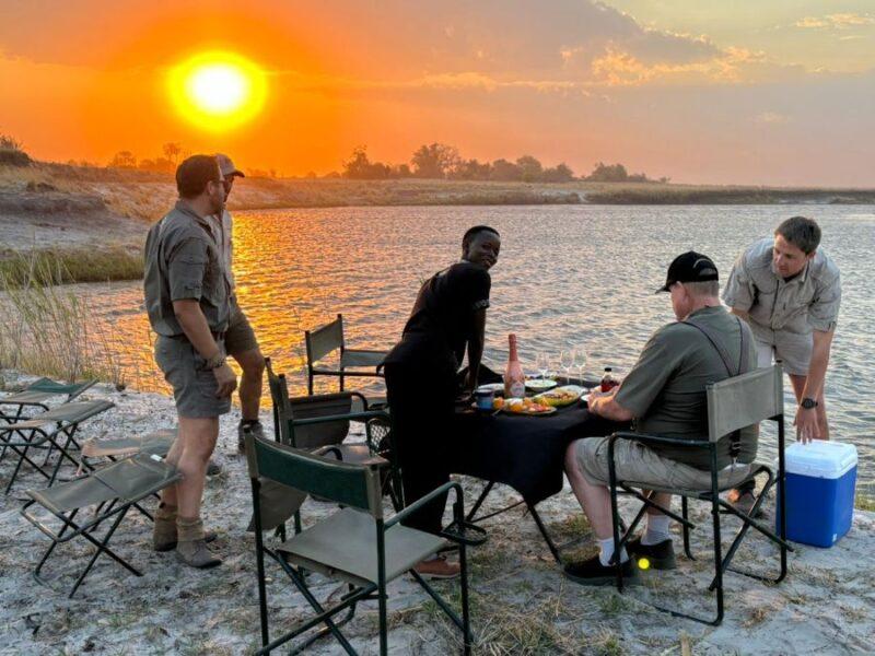 group of people relaxing in the Caprivi, next to the river