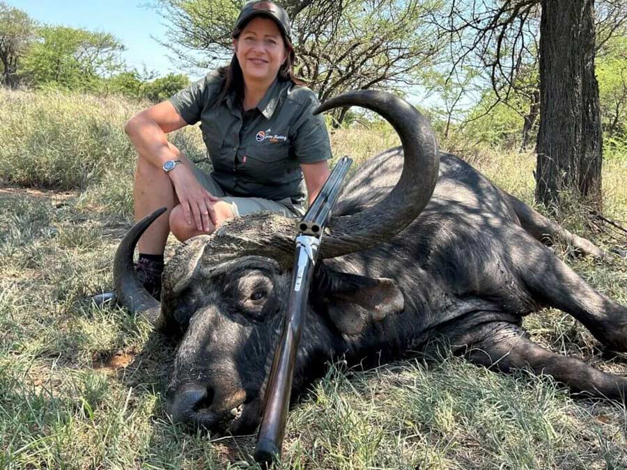 Tamlyn with her buffalo, after a successful after a Cape buffalo game hunting safari