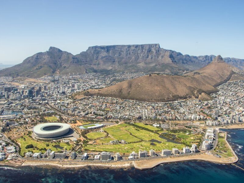 Aerial shot over Cape Town area showing Table Mountain in the background.